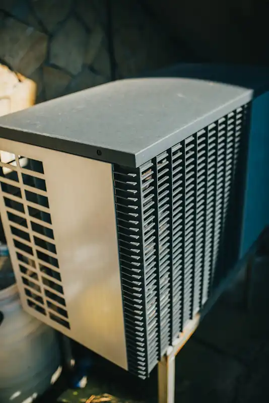 Outdoor air conditioner unit installed next to a home
